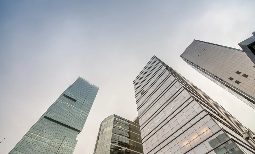 Modern office skyscrapers under a cloudy, overcast sky