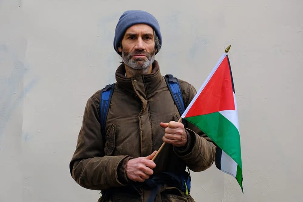 Peter Oswald with Palestinian flag.