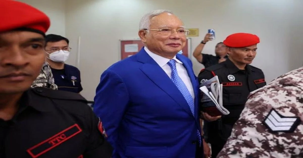 Malaysia halves former PM Najib's prison term