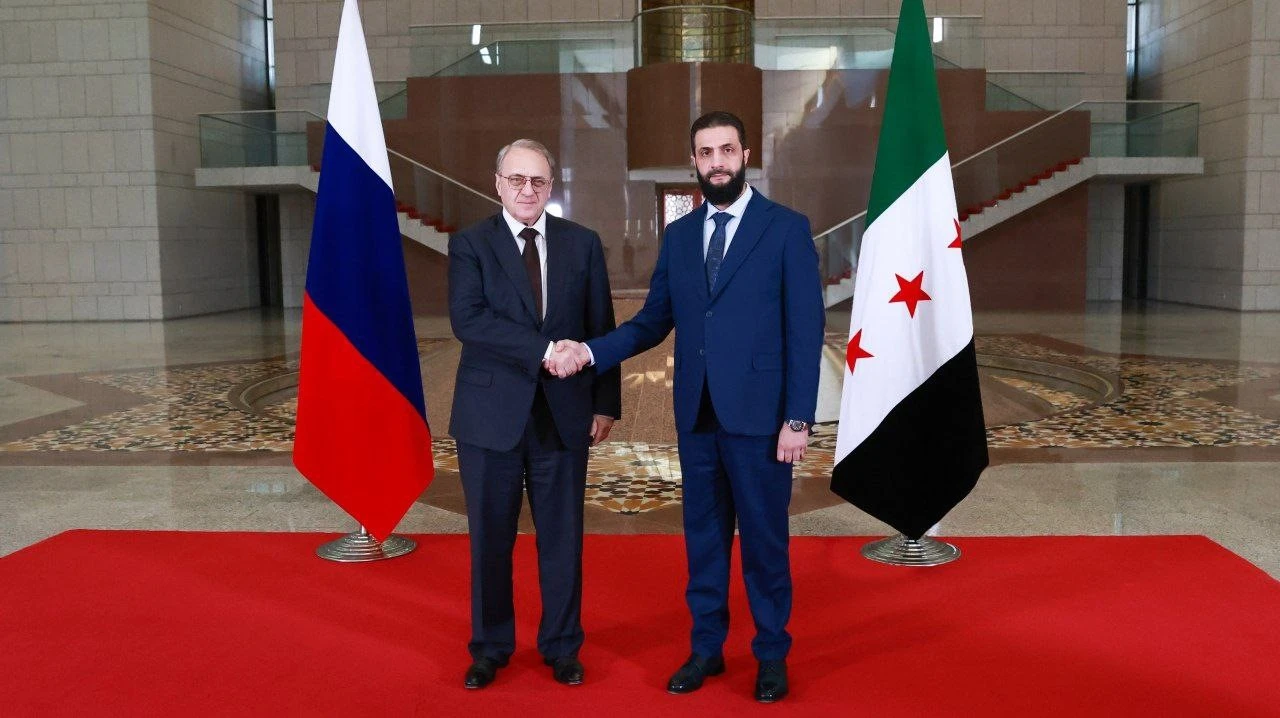 Photo shows Russian Deputy Foreign Minister Mikhail Bogdanov and Syria’s new leader, Ahmad al-Sharaa, shaking hands during a meeting in Damascus