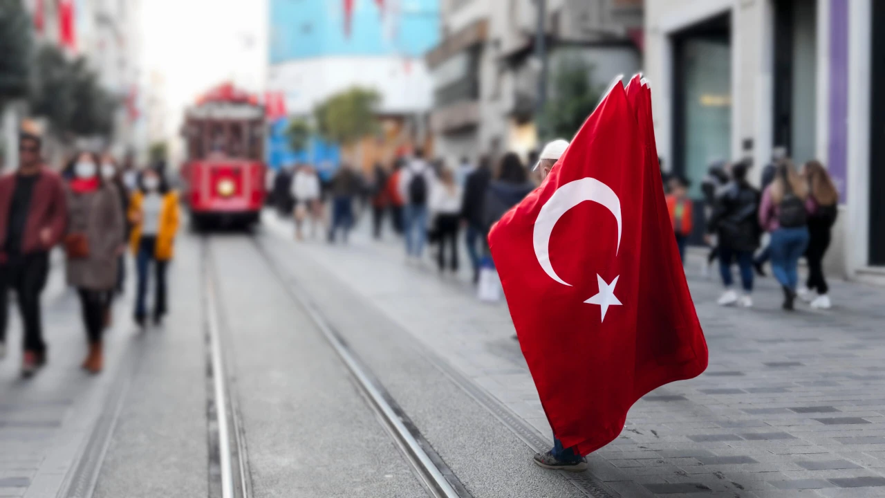 Photo shows a man holding Turkish flag