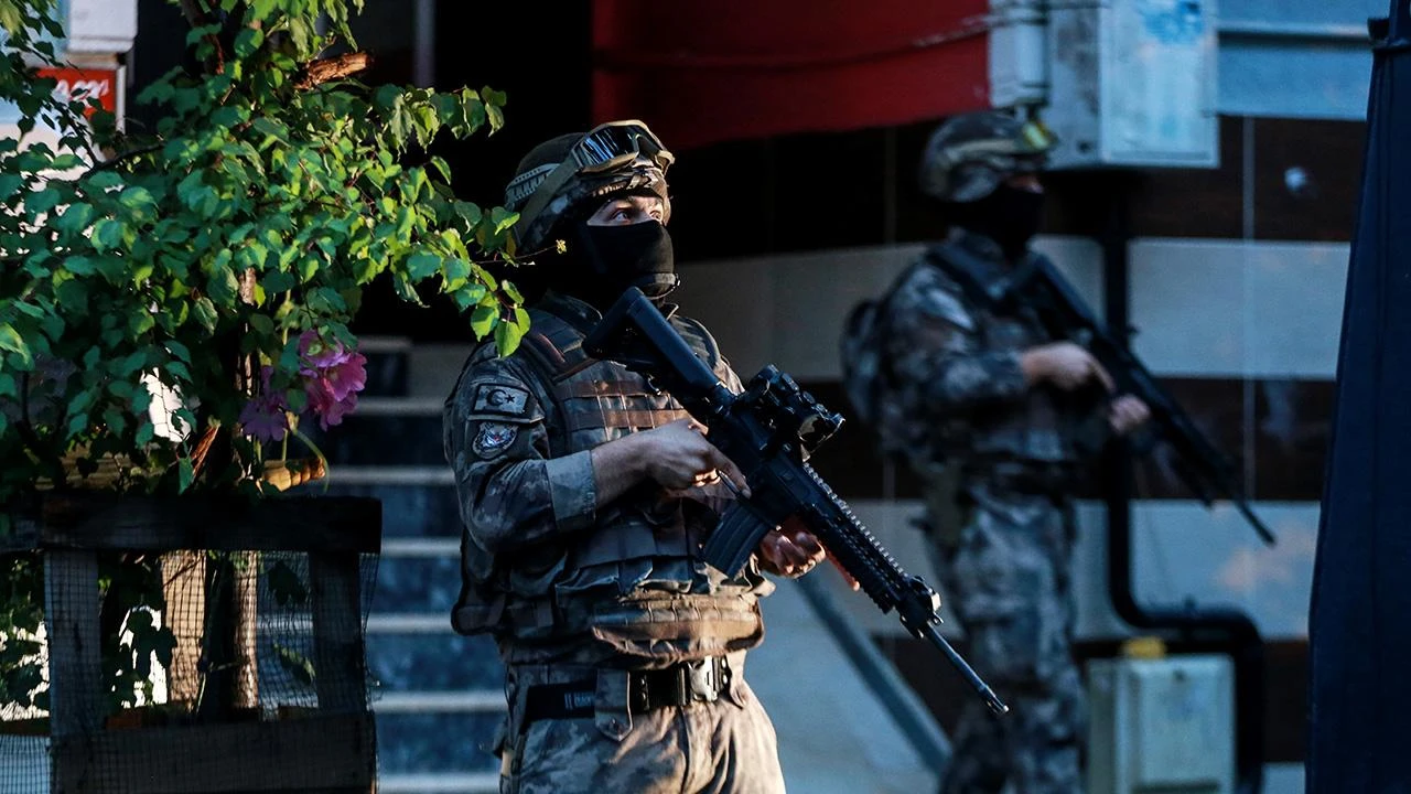 Turkish Police Department of Special Operations officers standing with their weapons during an operation