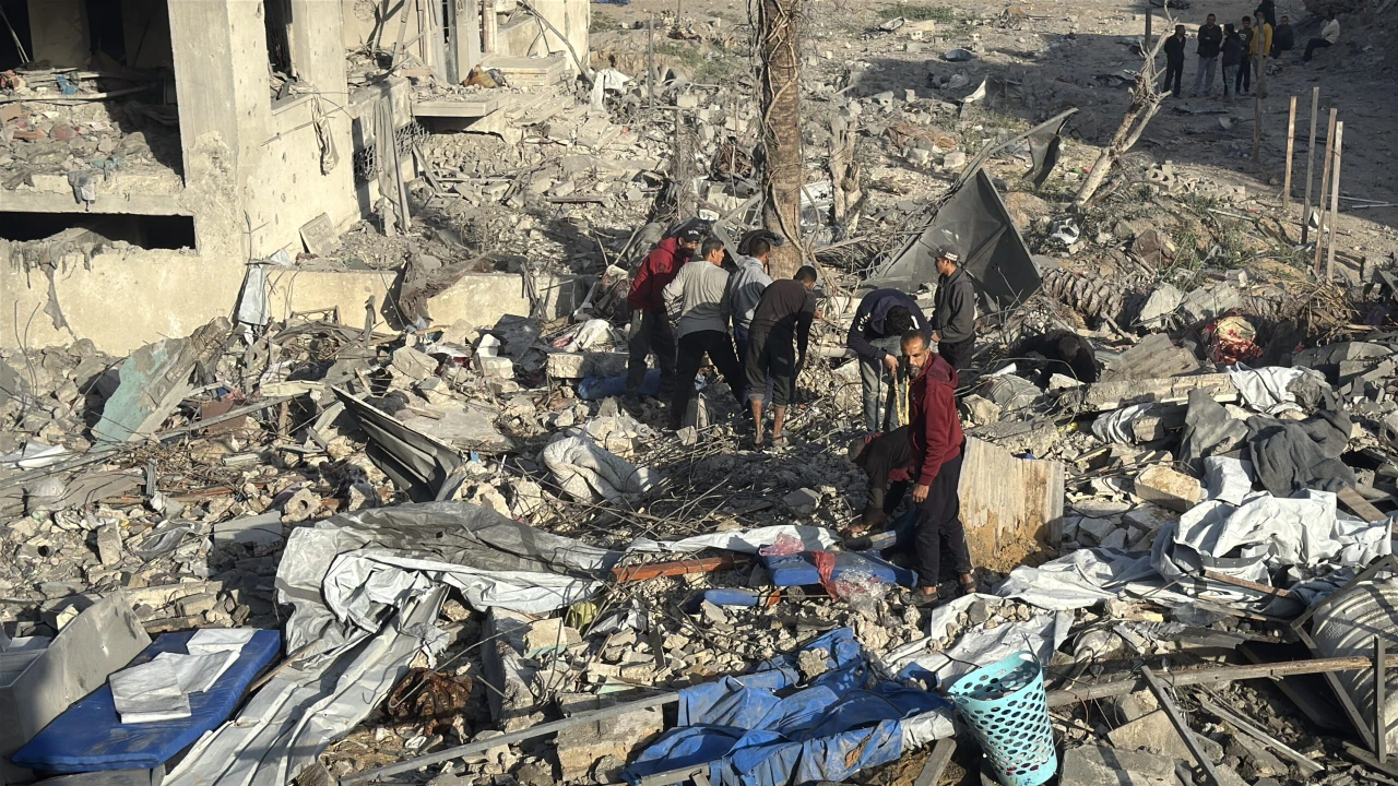 Photo shows people amid rubbles of a collapsed building.