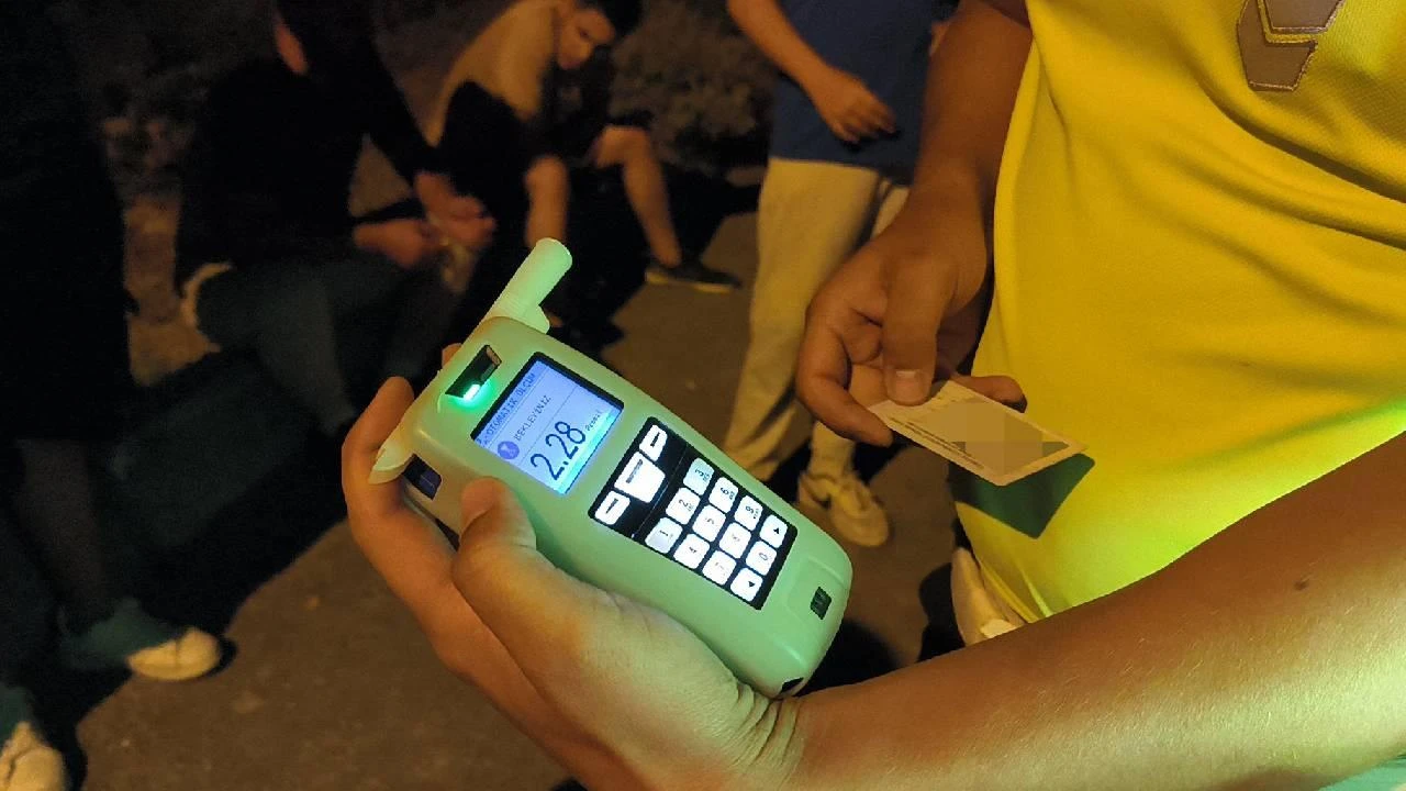 Traffic police conduct a security check with a breathalyzer in hand