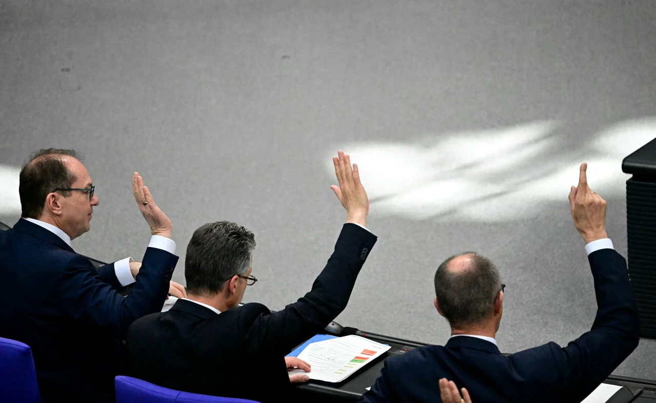 Germany approves trillion-euro defense boost amid Trump-NATO concerns 2 photo shows, from left to right, Friedrich Merz, leader of Germany's conservative Christian Democratic Union (CDU) party, CDU parliamentary managing director Thorsten Frei and the parliamentary group leader of the Bavarian conservative Christian Social Union (CSU) party Alexander Dobrindt raise their hands during a vote during a session at the Bundestag