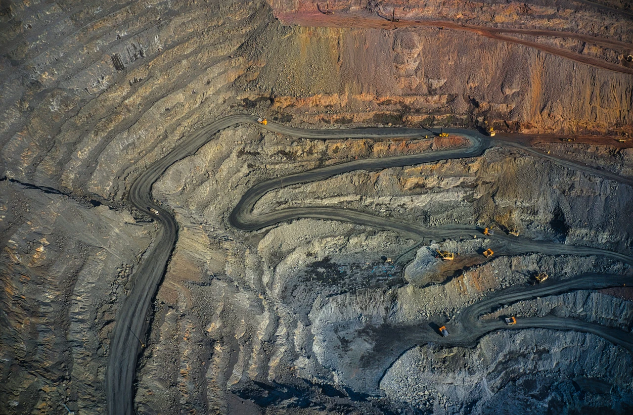 Extraction of minerals with the help of special equipment in the warm evening light in picturesque Ukraine, aerial panoramic drone shot. (Adobe Stock Photo)