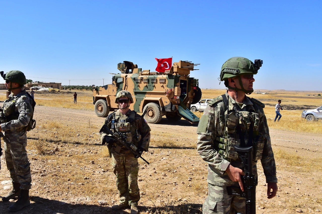 Photo shows Turkish and U.S. soldiers patrol together in Northern Syria.