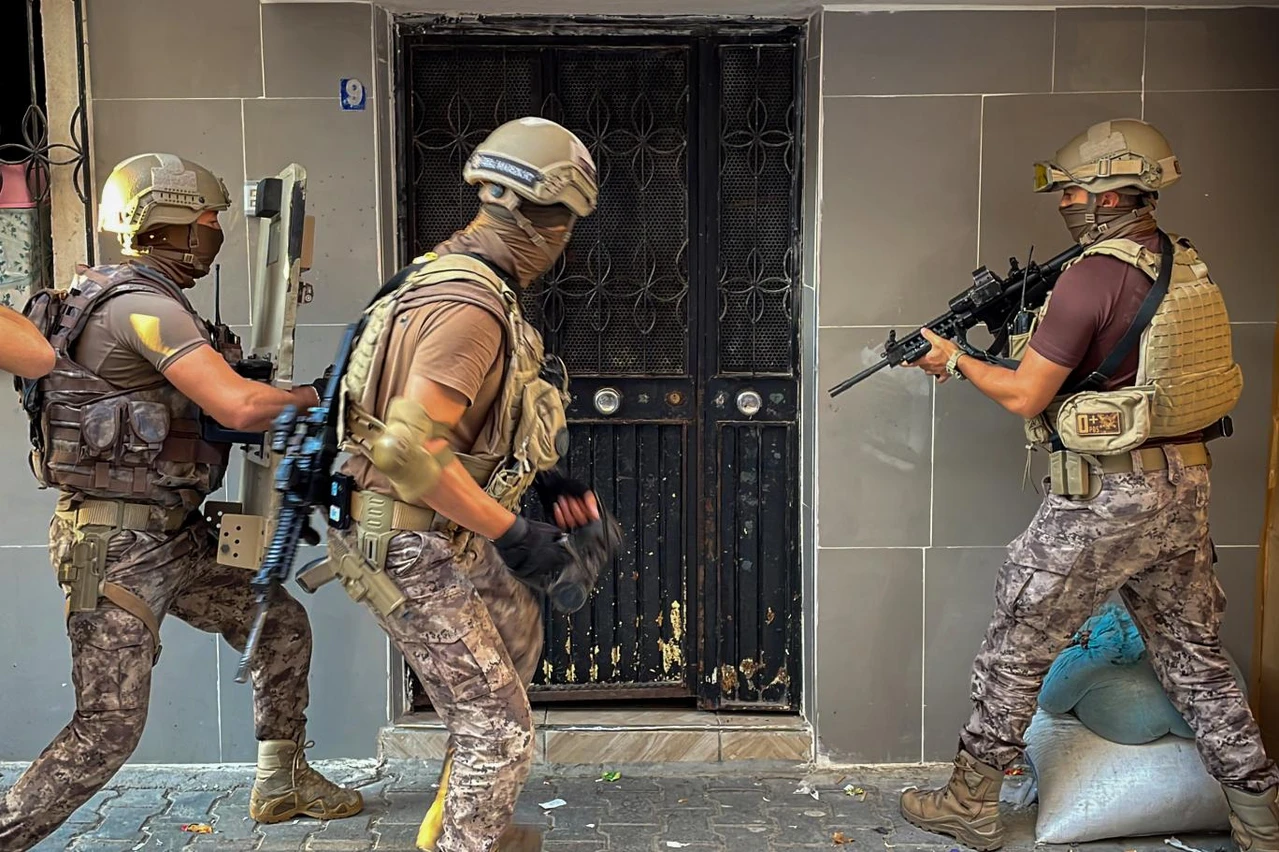 Turkish police officers entering a building