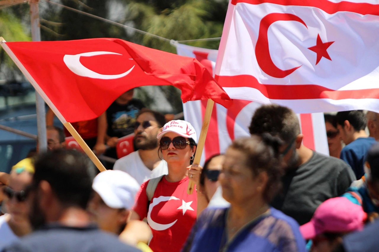 People wave Turkish Cypriot flags along with Turkish flags