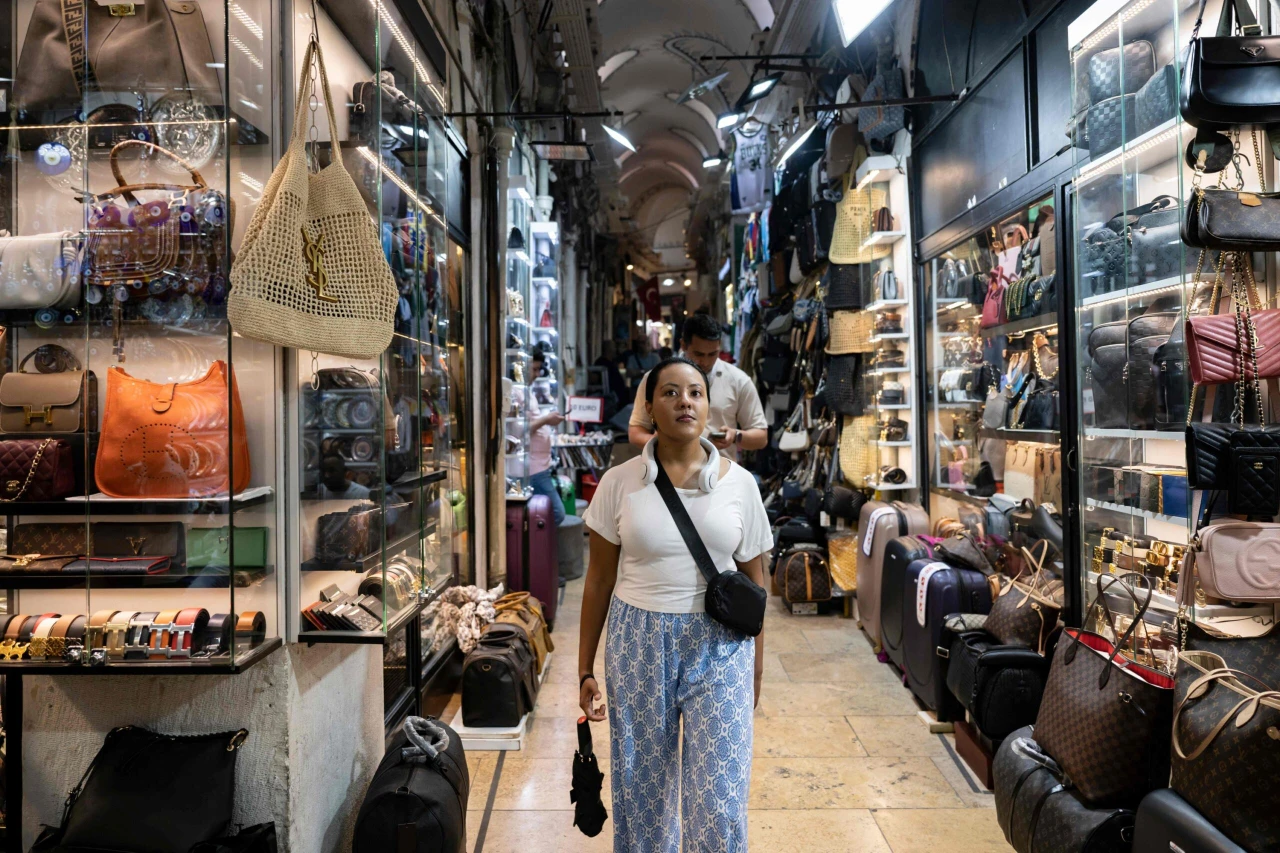 Visitors walk through the historic Grand Bazaar in Istanbul, Türkiye, passing by shops on July 9, 2024.