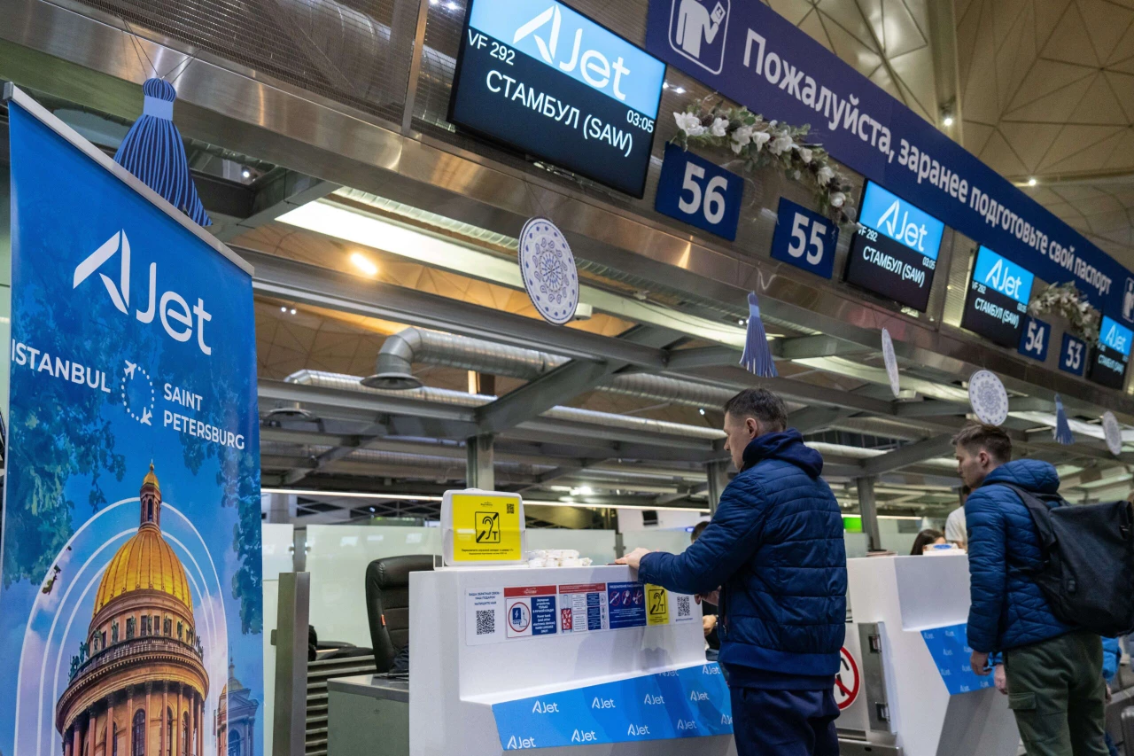 Passengers check in for AJet’s flight