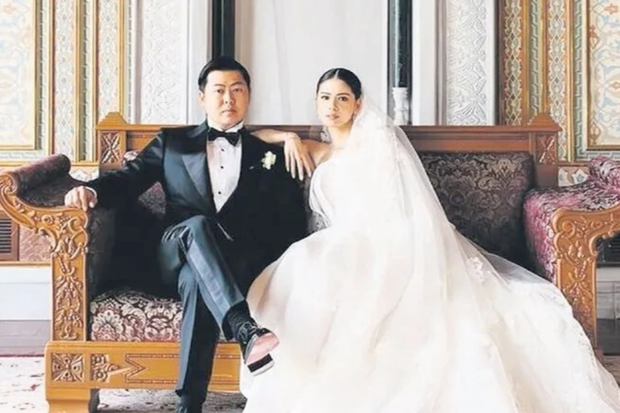 Bride Adelle Odelia Tanuri and groom Phillip Tjipto sit elegantly on a decorative couch during their wedding in Istanbul, Türkiye.