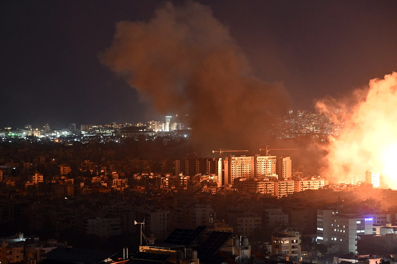 Photo shows smoke rising over residential area.