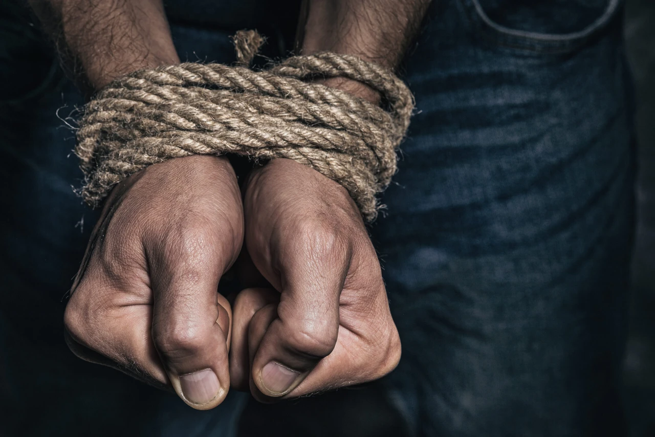 Mens hands tied with a rope