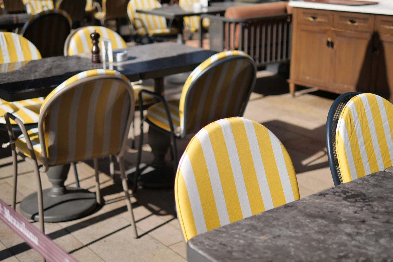 Outdoor restaurant tables with yellow chairs in an Istanbul setting