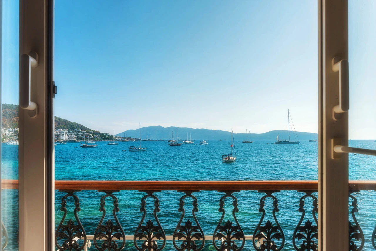 Window view from hotel on turquoise water of Aegean sea with yachts in Bodrum town, Mugla province, Turkey, Popular tourist summer resort in Turkey