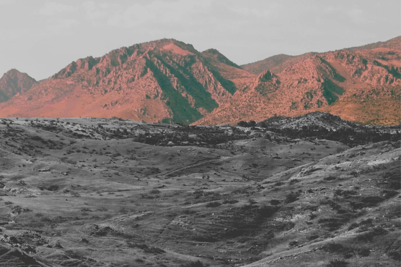 View of the Zagros Mountains with accumulated sediments along the depression at their base.