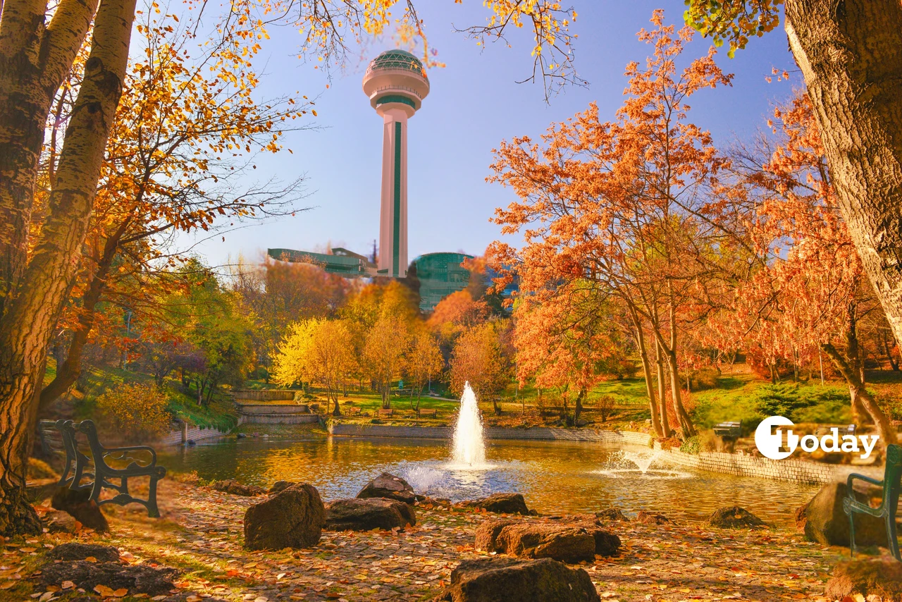 Ramadan 2025 in Ankara - A scenic view of Ankara’s Atakule tower rising above a park with autumn foliage, a peaceful fountain, and benches, offering a tranquil retreat in the heart of Türkiye’s capital.