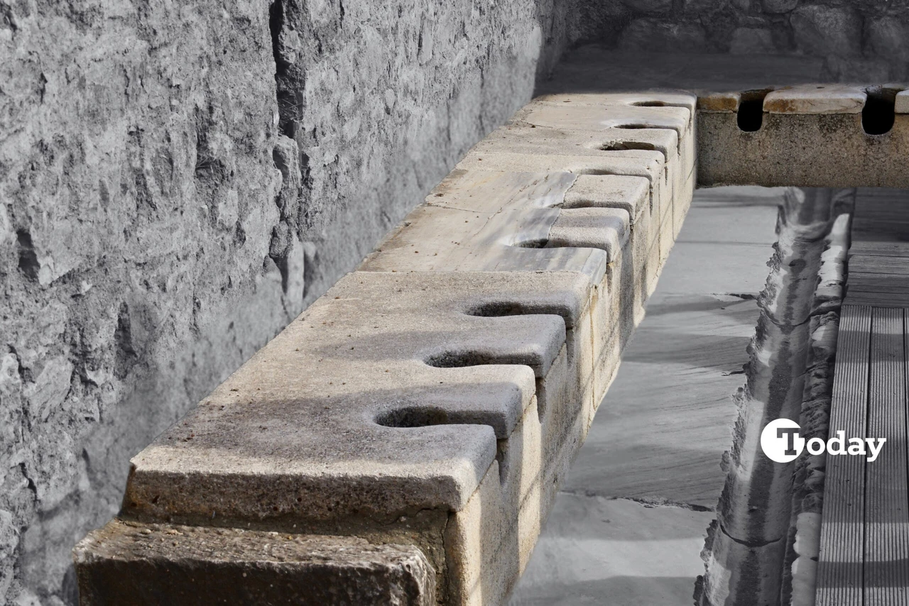 A photo showing the ancient public latrines in Ephesus, showcasing the historical significance of the public sanitation system in İzmir, Türkiye.