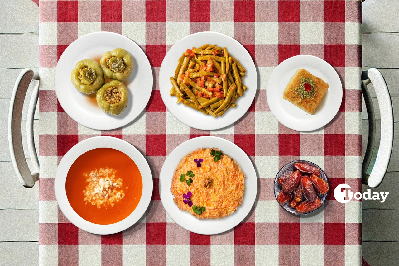 A traditional Turkish iftar meal on a checkered tablecloth, featuring tomato soup, grated carrot yogurt dip, stuffed bell peppers, stir-fried green beans, and revani dessert.