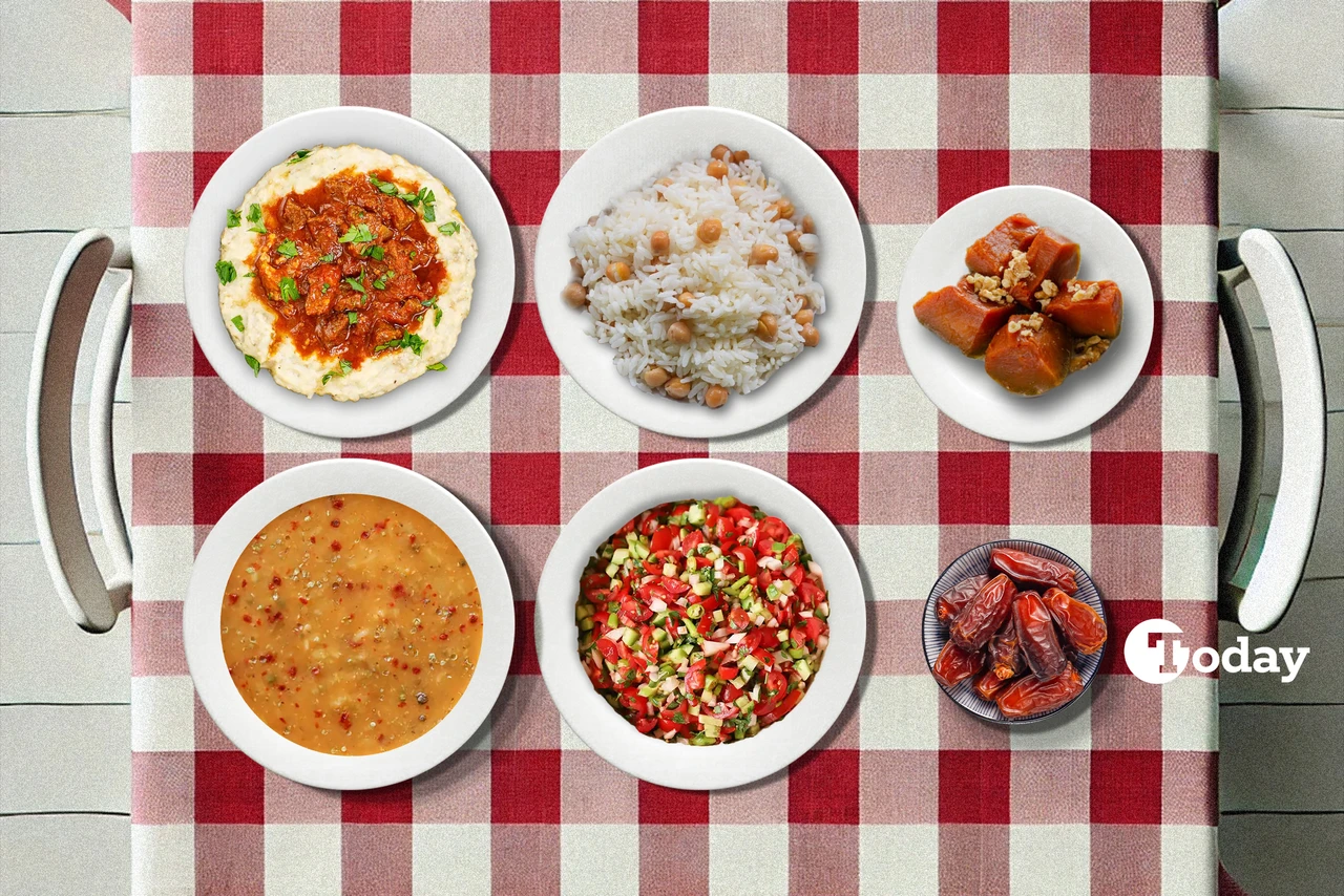 A Turkish iftar spread on a checkered tablecloth, featuring Ezogelin soup, Coban Salatasi, Hunkar Begendi, chickpea rice pilaf, and baked pumpkin with tahini and walnuts.