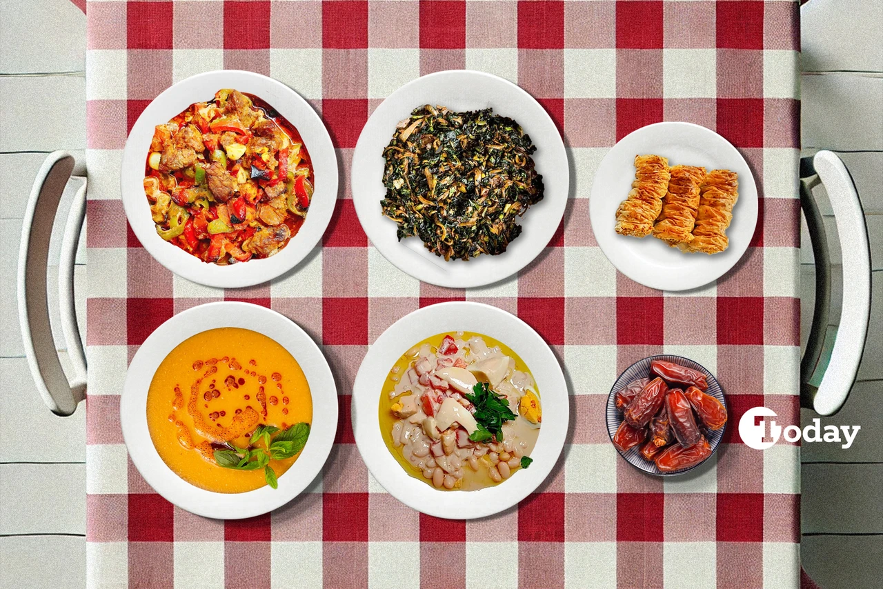 A top-down view of a red-and-white checkered tablecloth set with an iftar meal, including soup, bean salad, sautéed spinach, beef casserole, and baklava.