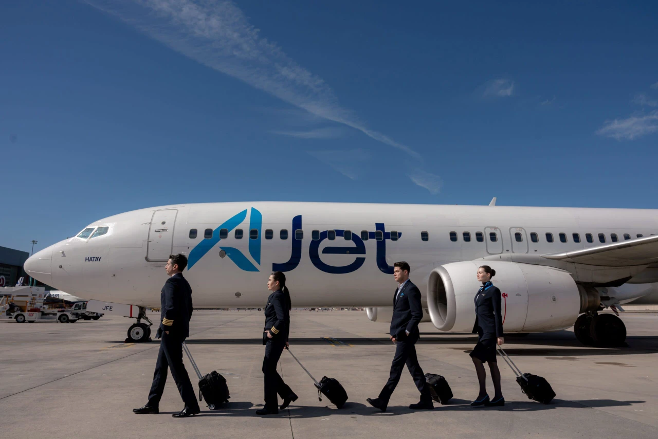 AJet flight crew walking past a parked aircraft