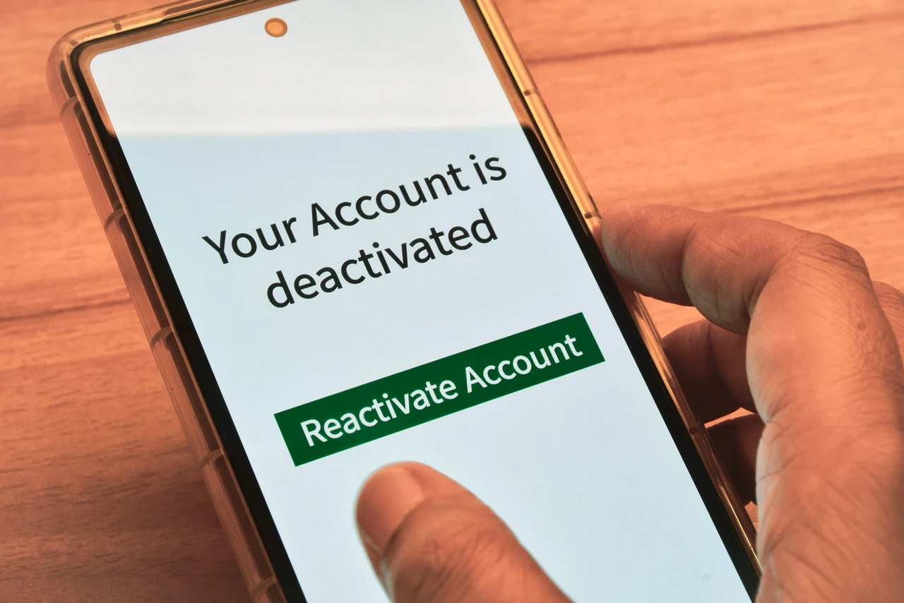 Cellphone with the message your account is deactivated. Reactivate a cancelled account concept. Digital display, selective focus.