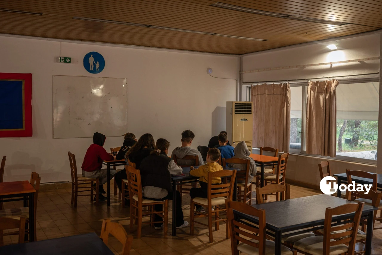 Teenagers and children using tablets and smartphones in the cafeteria of a summer camp in Agios Andreas, near Athens.