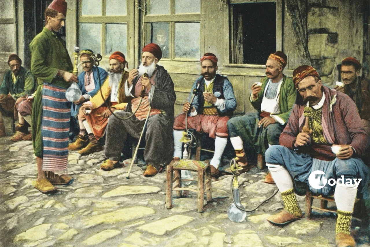 Men smoking hookah in front of a coffeehouse