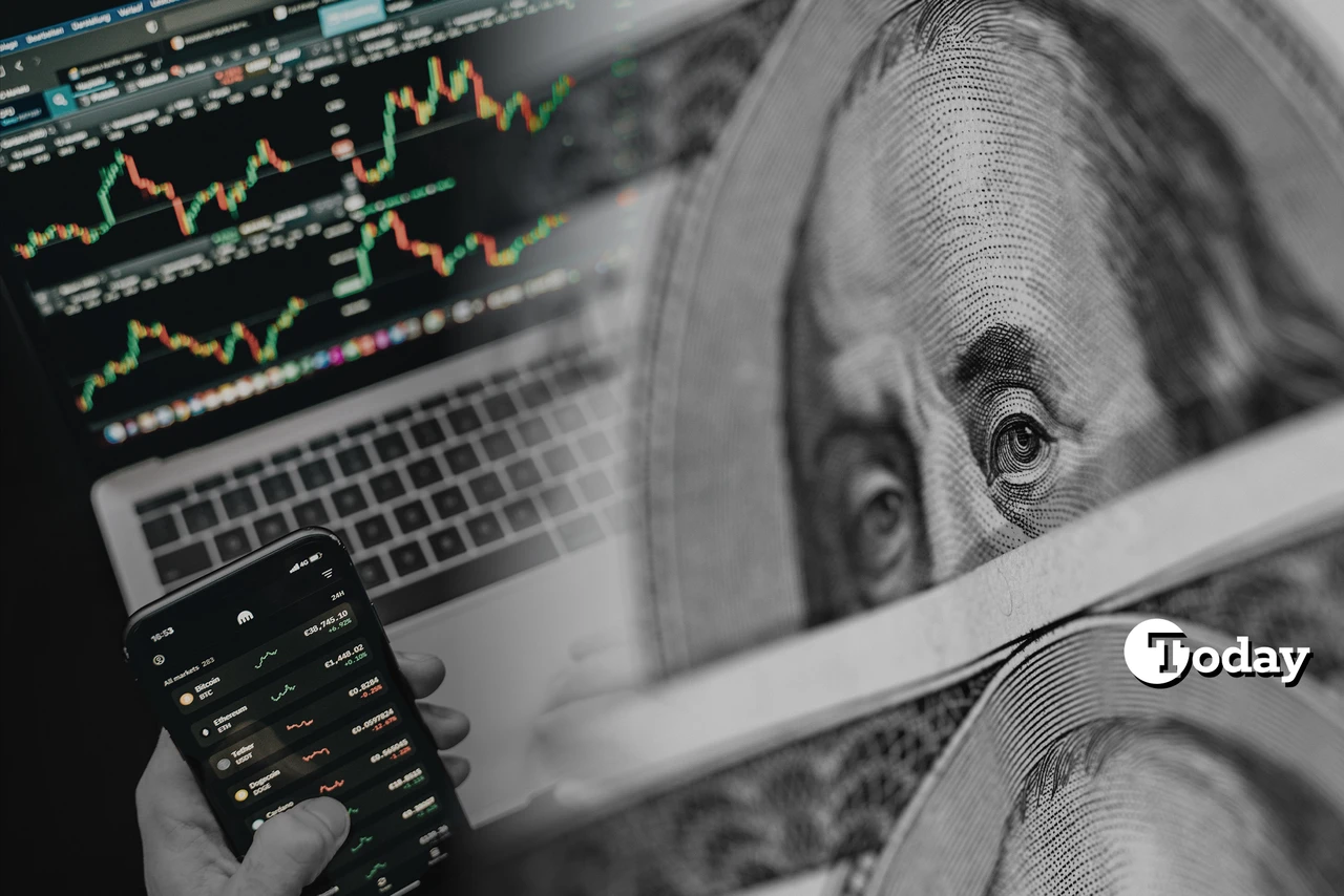 Laptop with stock charts, dollar bill overlay, smartphone trading screen