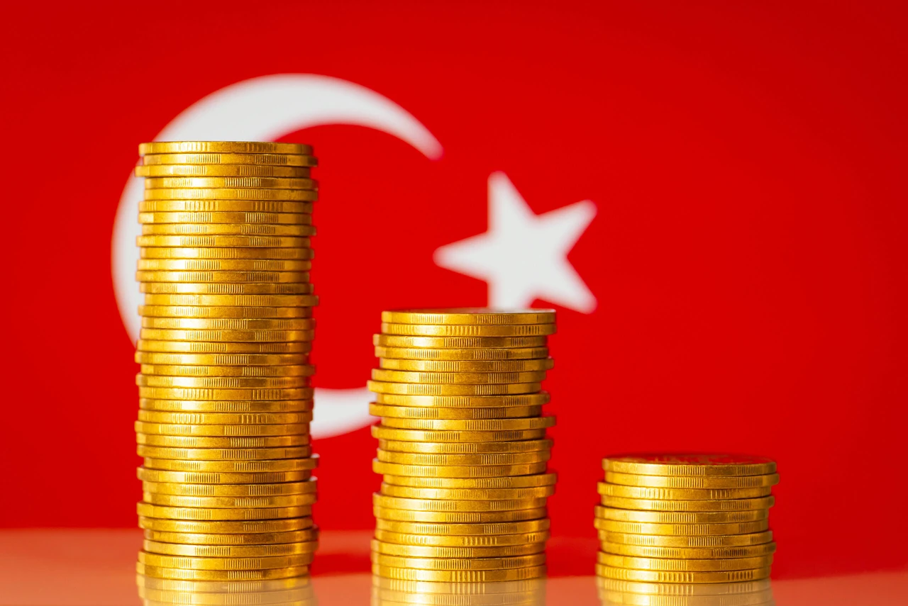 Gold coins stacks with flag of Türkiye on the background