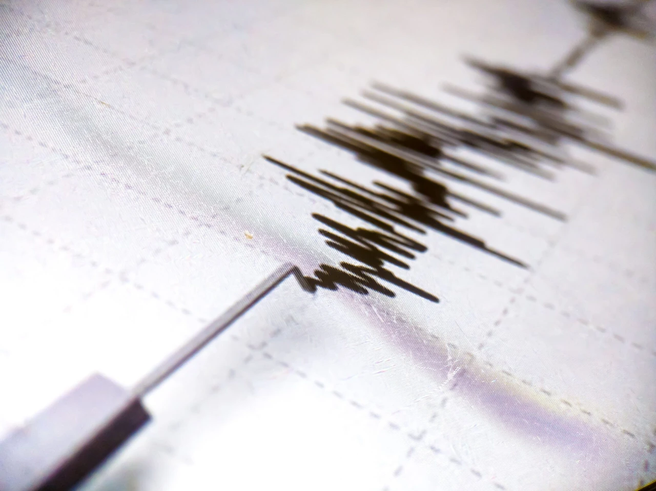 Photo shows a seismometer printing line records earthquake tremors.