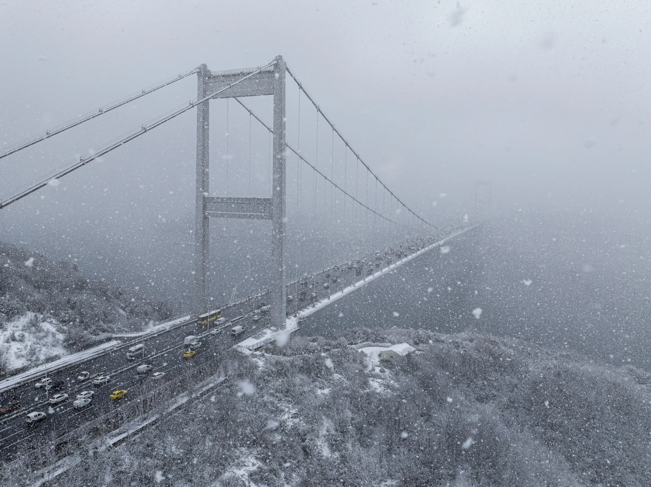 An aerial view of the Bosporus and its surroundings, blanketed in white as snowfall continues in higher areas of Istanbul.