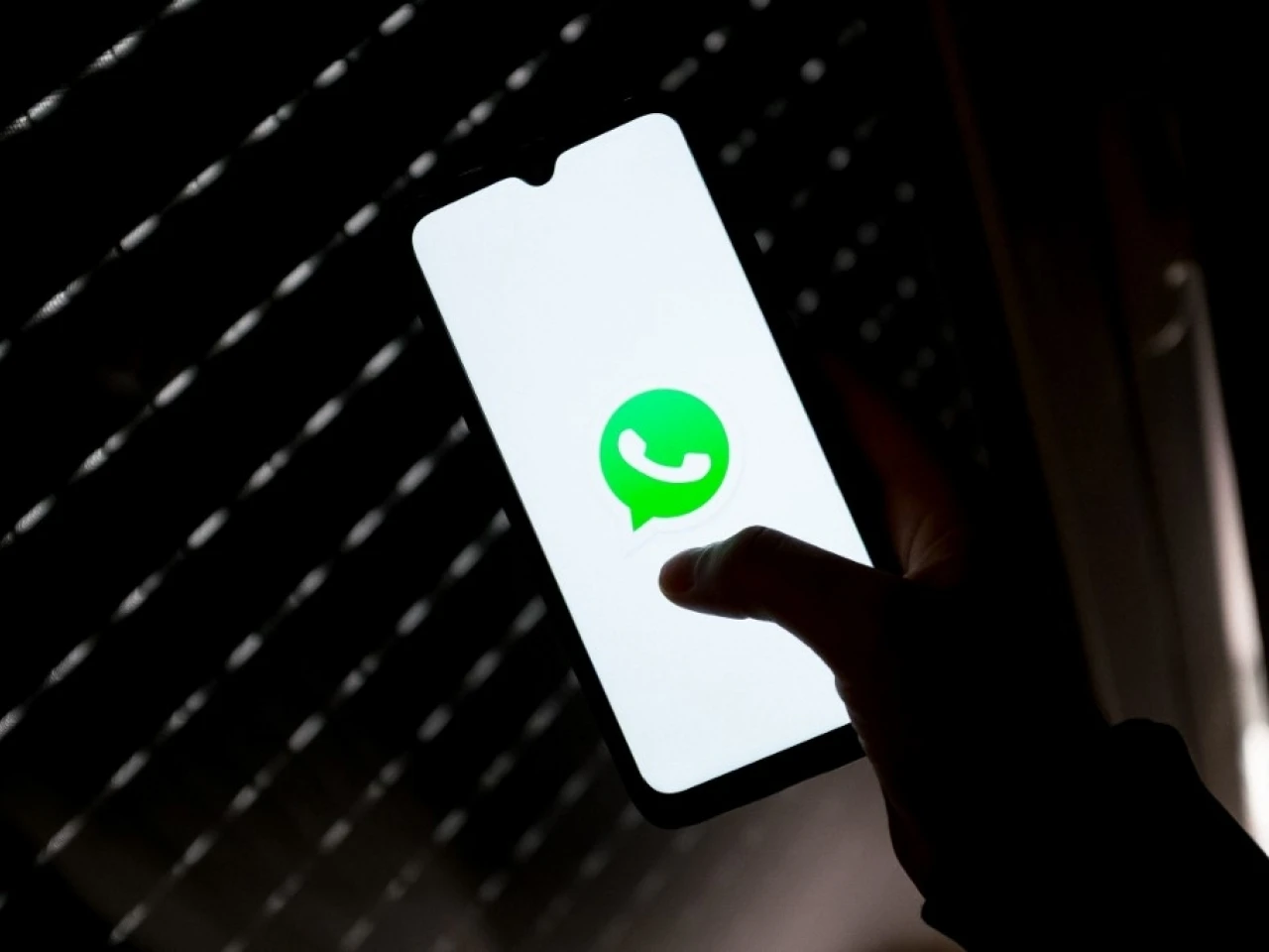 WhatsApp logo displayed on a phone screen in this illustration photo