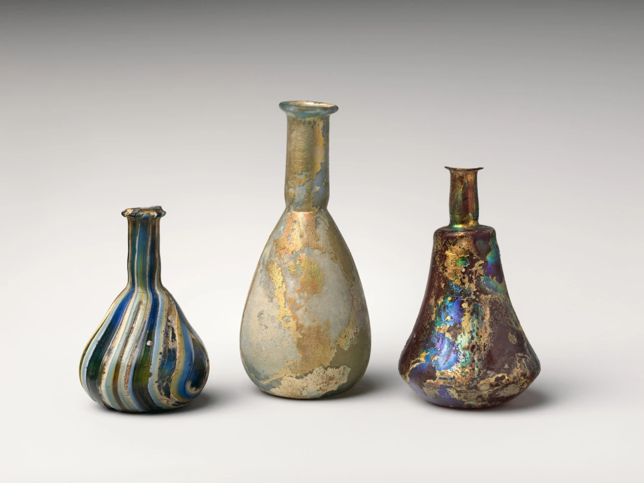 three ancient glass blown perfume bottles made by the Romans