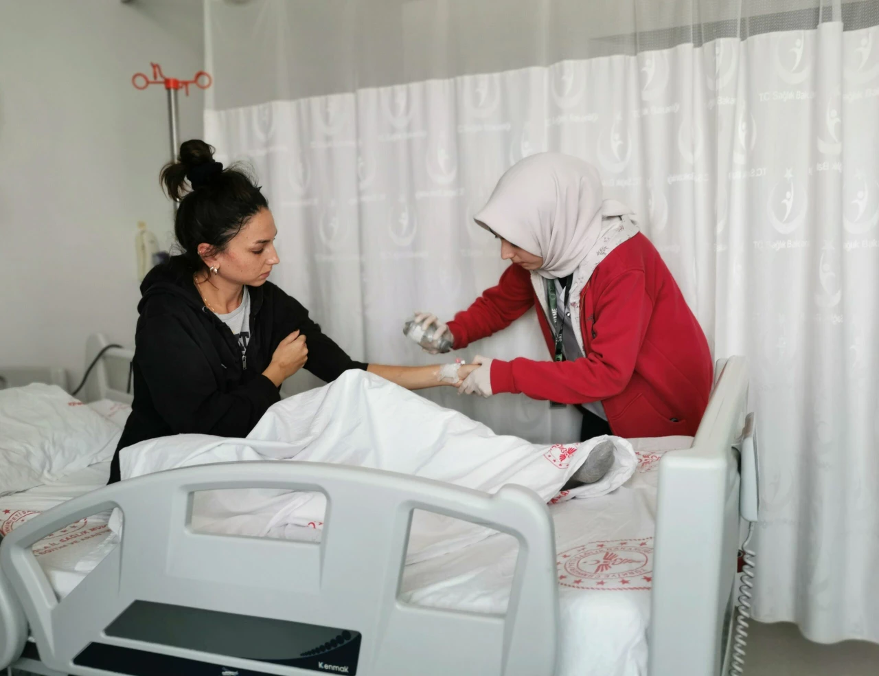 A young girl sitting in a hospital chair during chemotherapy treatment at Muğla Provincial Hospital in Türkiye.