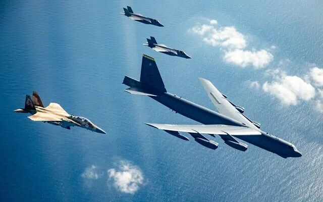 Israeli Air Force F-15I and F-35I fighter jets fly alongside a US B-52 bomber