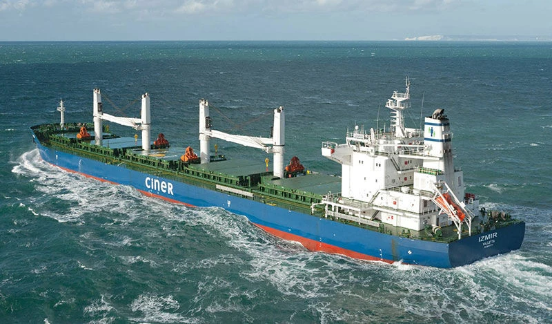 A bulk carrier sails through the open seas