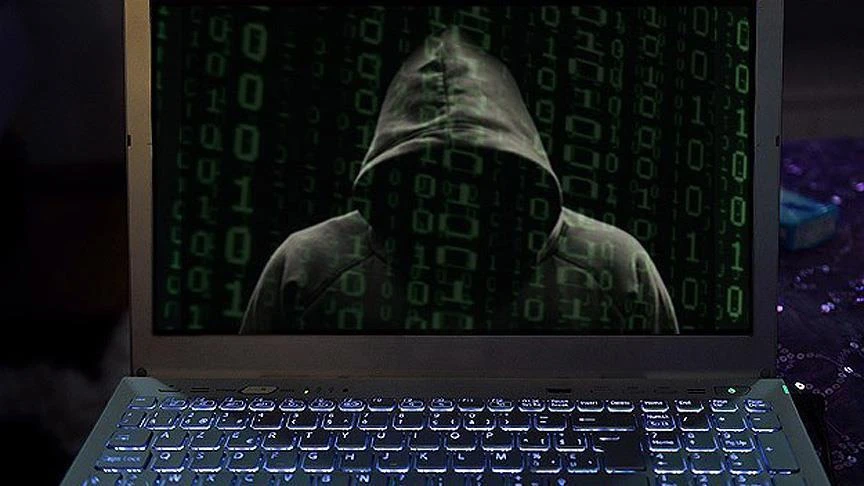 A person with a hoodie on a laptop screen