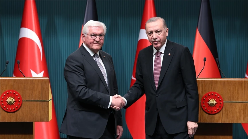 Photo shows Turkey's President Erdogan and German President Frank-Walter Steinmeier shaking hands.