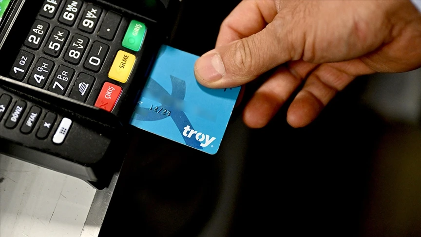 File photo shows a person inserts a TROY card into a point-of-sale (POS) terminal. (AA Photo)