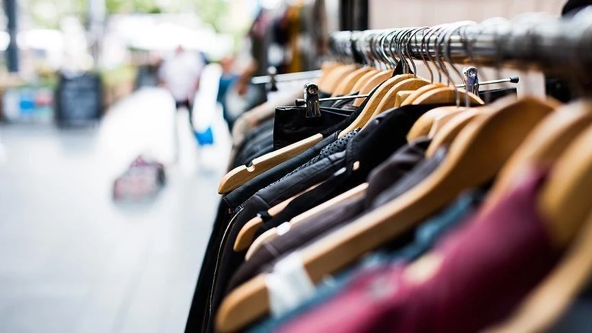 Clothes on hangers in an outdoor shopping district