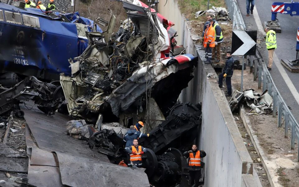 Rescue workers use a crane to clear debris from the tracks after a train collision in Tempi, approximately 235 miles (376 km) north of Athens, near Larissa, Greece