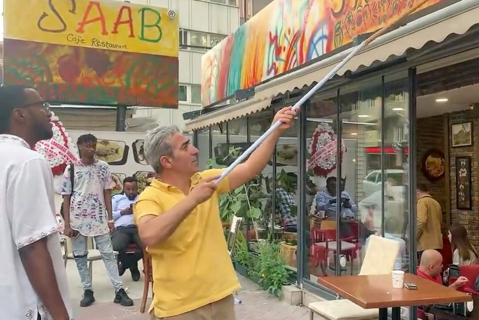 SAAB Cafe's original sign, featuring non-Turkish language and cultural symbols, was taken down by authorities, reflecting discrimination in Türkiye