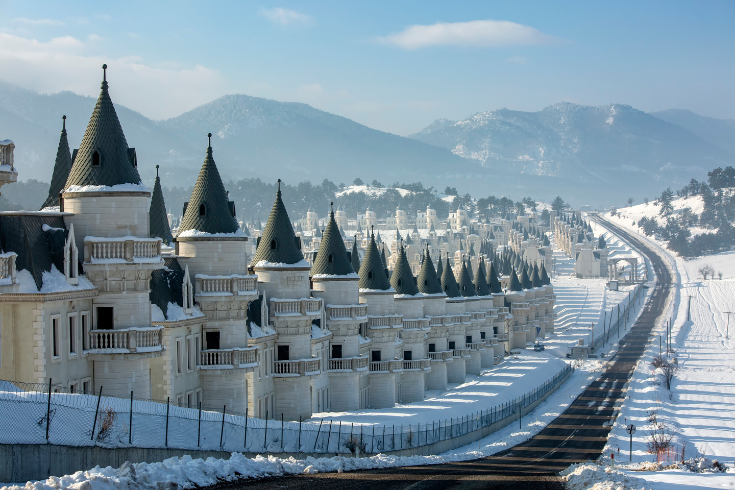 Closer view of snow-draped Burj Al Babas’ turreted villas amidst the mountains of Mudurnu, Bolu, Türkiye