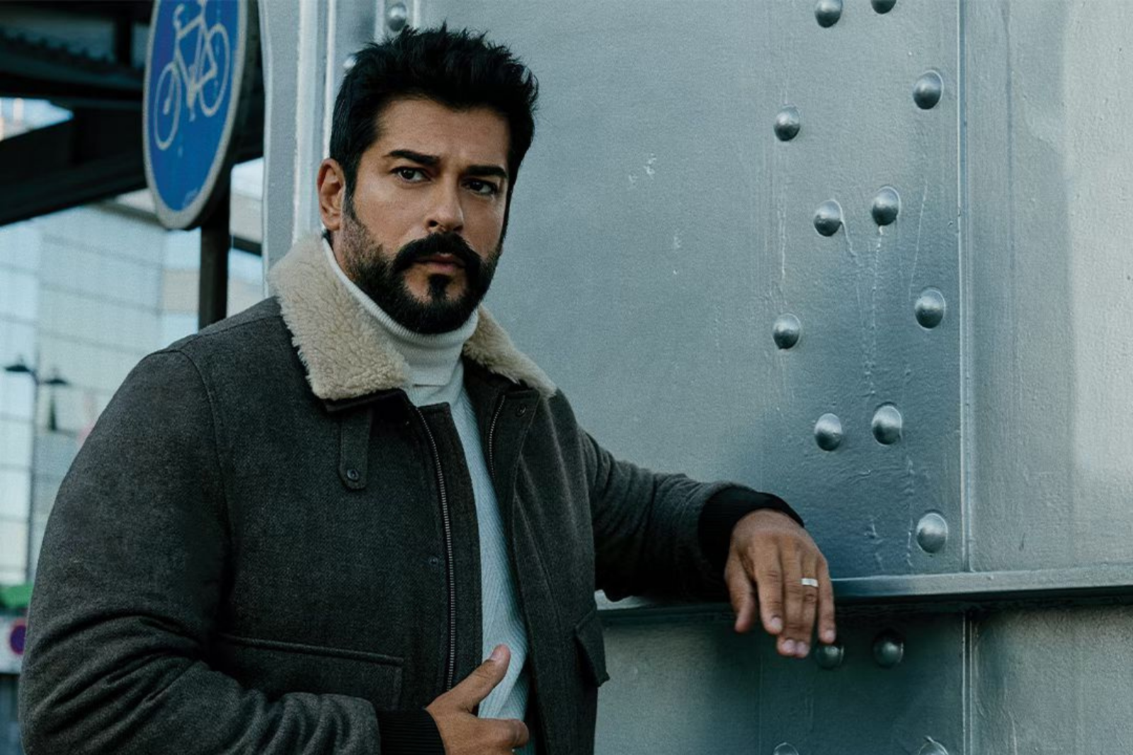 Burak Ozcivit poses in a stylish coat for a brand advertisement