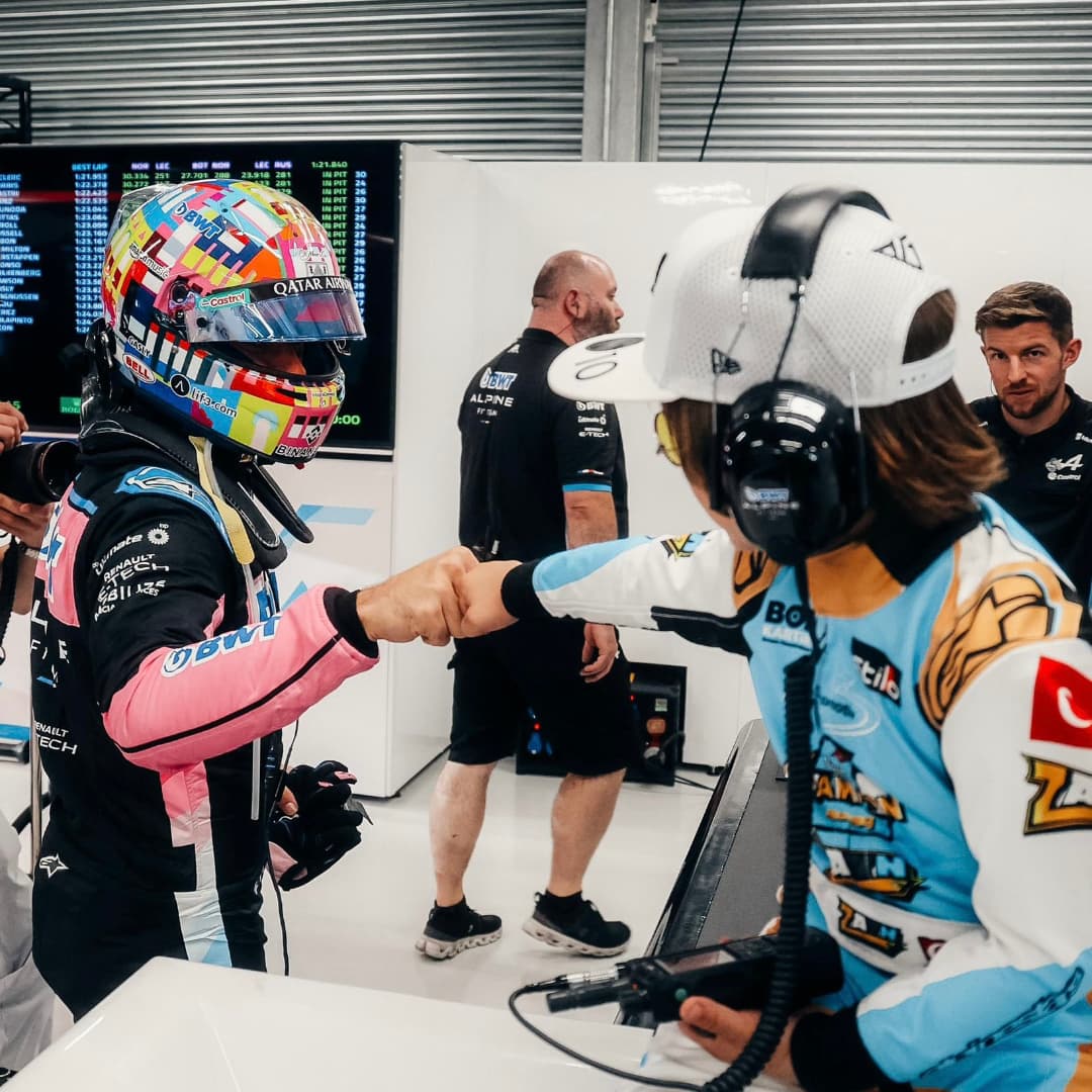 Pierre Gasly (L) and Zayn Sofuoglu (R) share a fist bump at Mercedes pit wall in Qatar, on Nov. 29, 2024. (Photo via X)