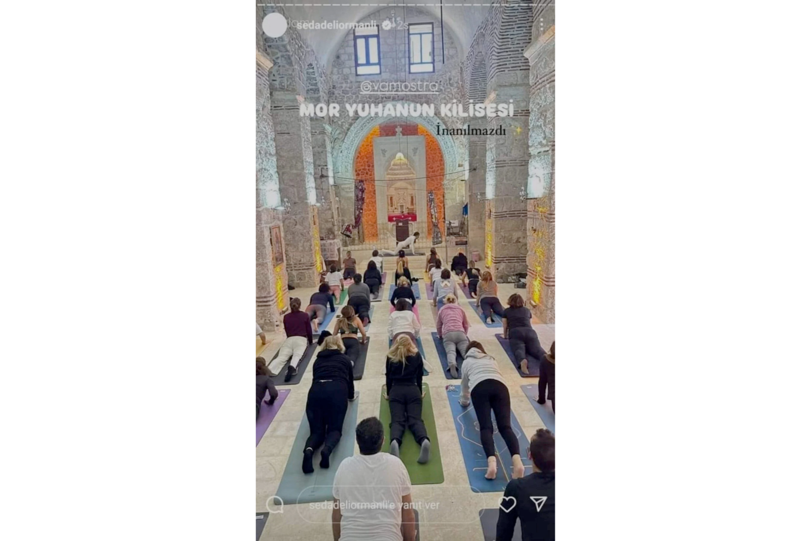 Participants perform yoga exercises with mats laid out inside Mor Yuhanon Church, an active 4th-century worship site in Dereici