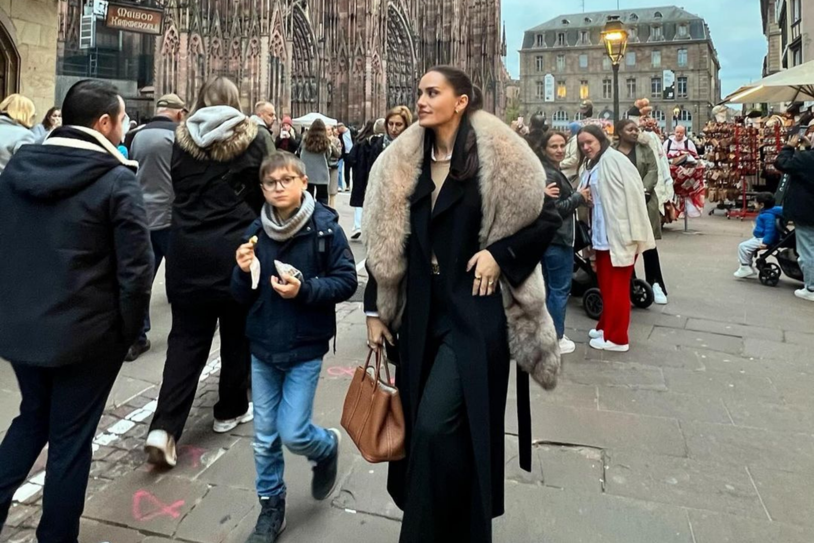 Fahriye Evcen walks through the streets wearing a cream-colored fur coat, drawing criticism on social media, Strasbourg, France,